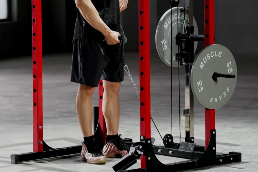 A man is using cable system to working out