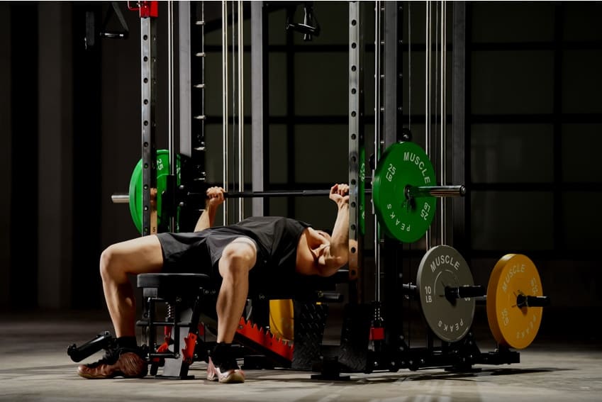 A man is lying on the weight bench and try to lifting a barbell