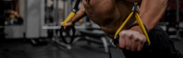 A man is doing DL with bands on the power rack