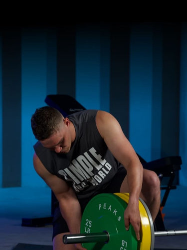 A man is organizing barbell pieces