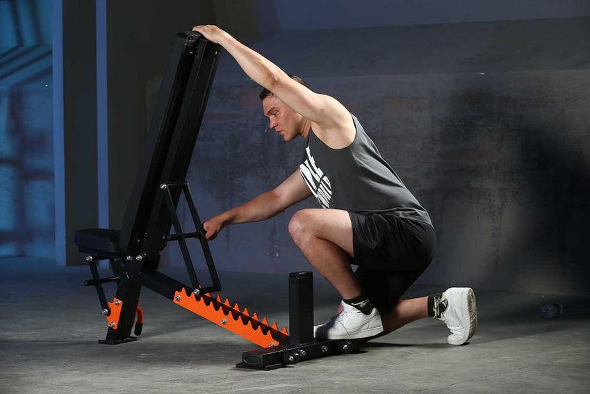 A man is adjust the adjustable weight bench