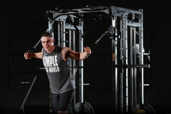 A man is woking out on the smith machine