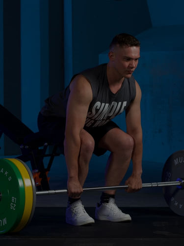 A man is trying to lifting a barbell