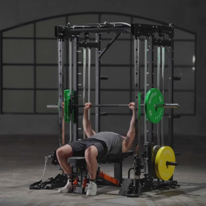 A man is working out on smith machine